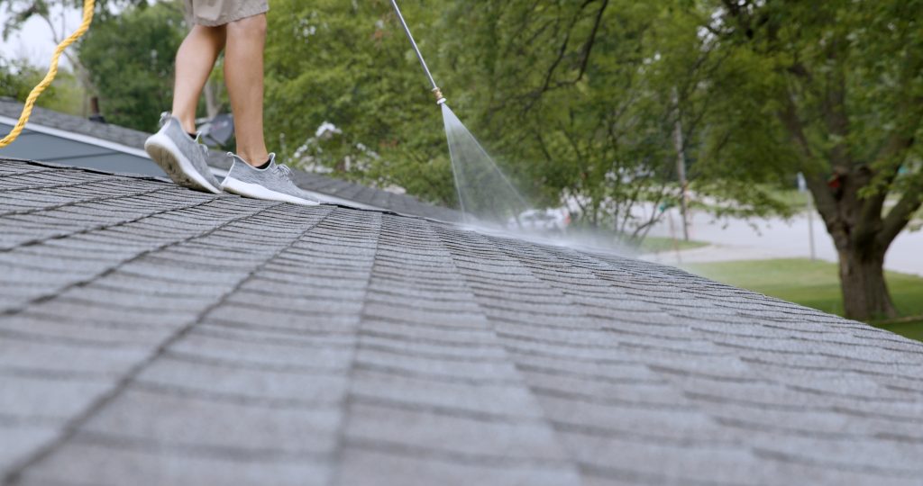Roof Longevity technician applying Peak 301 to an asphalt shingle roof in Idaho