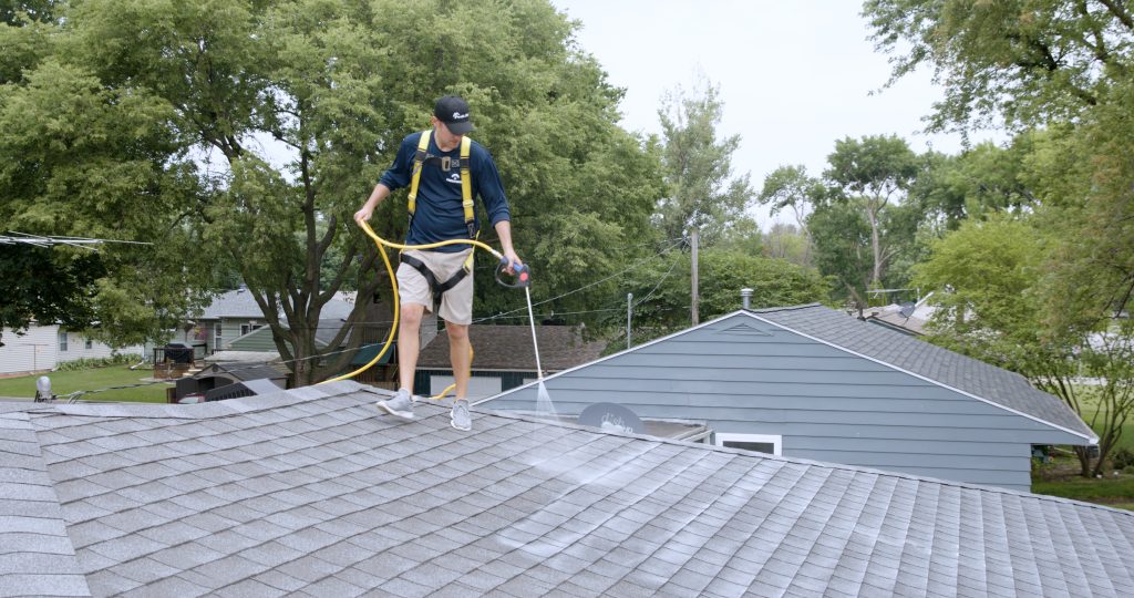 Roof Longevity technician applying Peak 301 to an asphalt shingle roof in Idaho