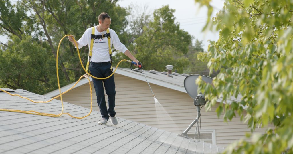 Roof Longevity technician applying Peak 301 to an asphalt shingle roof in Idaho